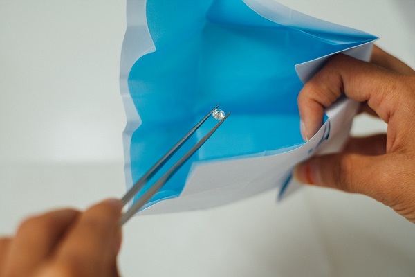 Placing polished diamond in Forevermark package, De Beers Group Industry Services, Surat.jpg